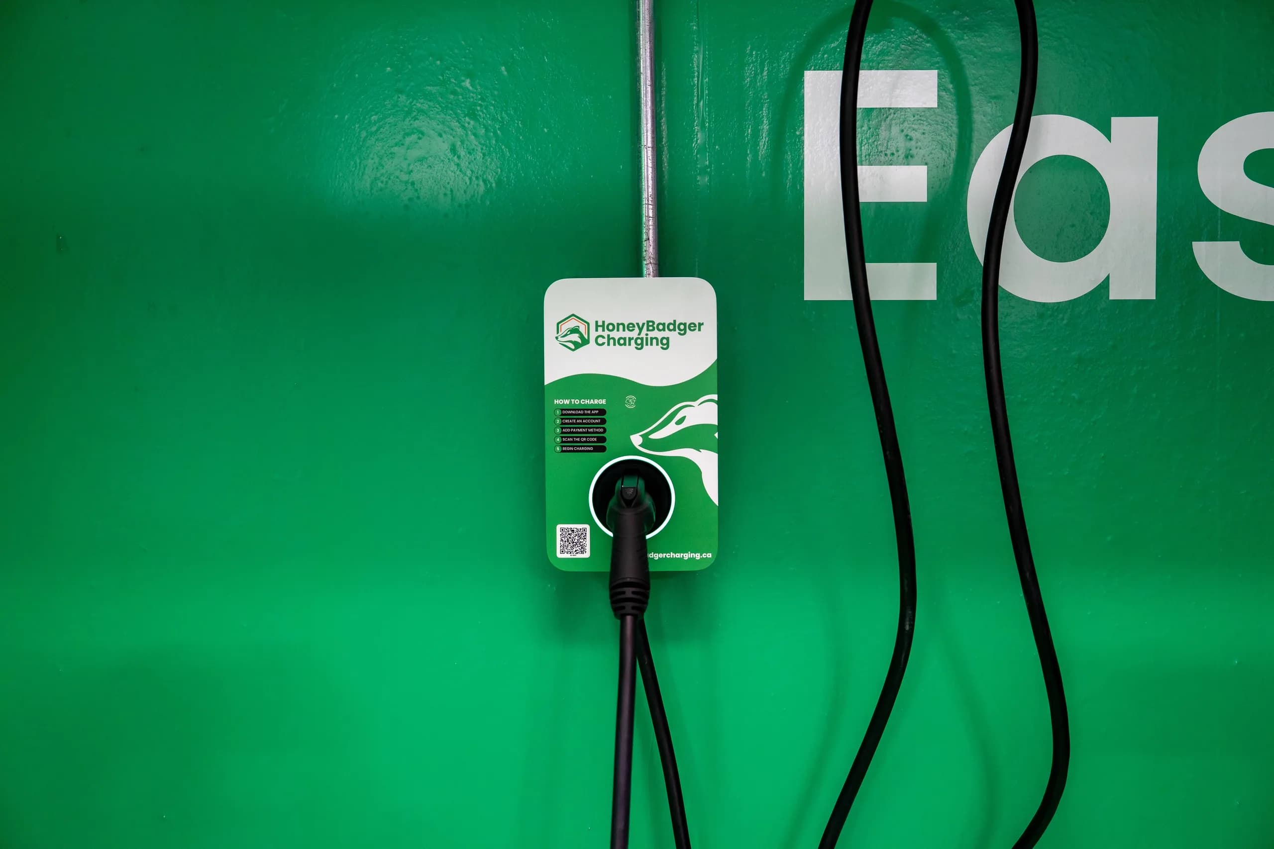 Woman using HoneyBadger EV Charger